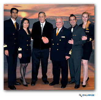 Levy (third from left) is pictured here with several members of the Carnival Paradise�s management team, including F&B Manager Ganesh Khalipe (far left); Guest Services Manager Kua Ngamkamolrat (second from left); Captain Vito Garuccio (third from right); Cruise Director Felipe Couto (second from right); and Housekeeping Manager Malgorzata Palucka.