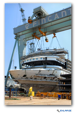 CIn the photo the massive enclosed bridge is maneuvered by cranes atop the Carnival Magic's superstructure.
