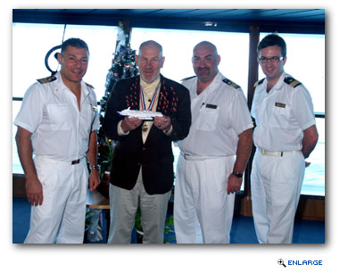 Filomena (second from left) is pictured here on the Carnival Miracle's bridge with the ship's officers, including Captain Rocco Lubrano (far left), Hotel Director Pierre B. Camilleri (second from right) and Guest Services Manager Phil Holmes.
